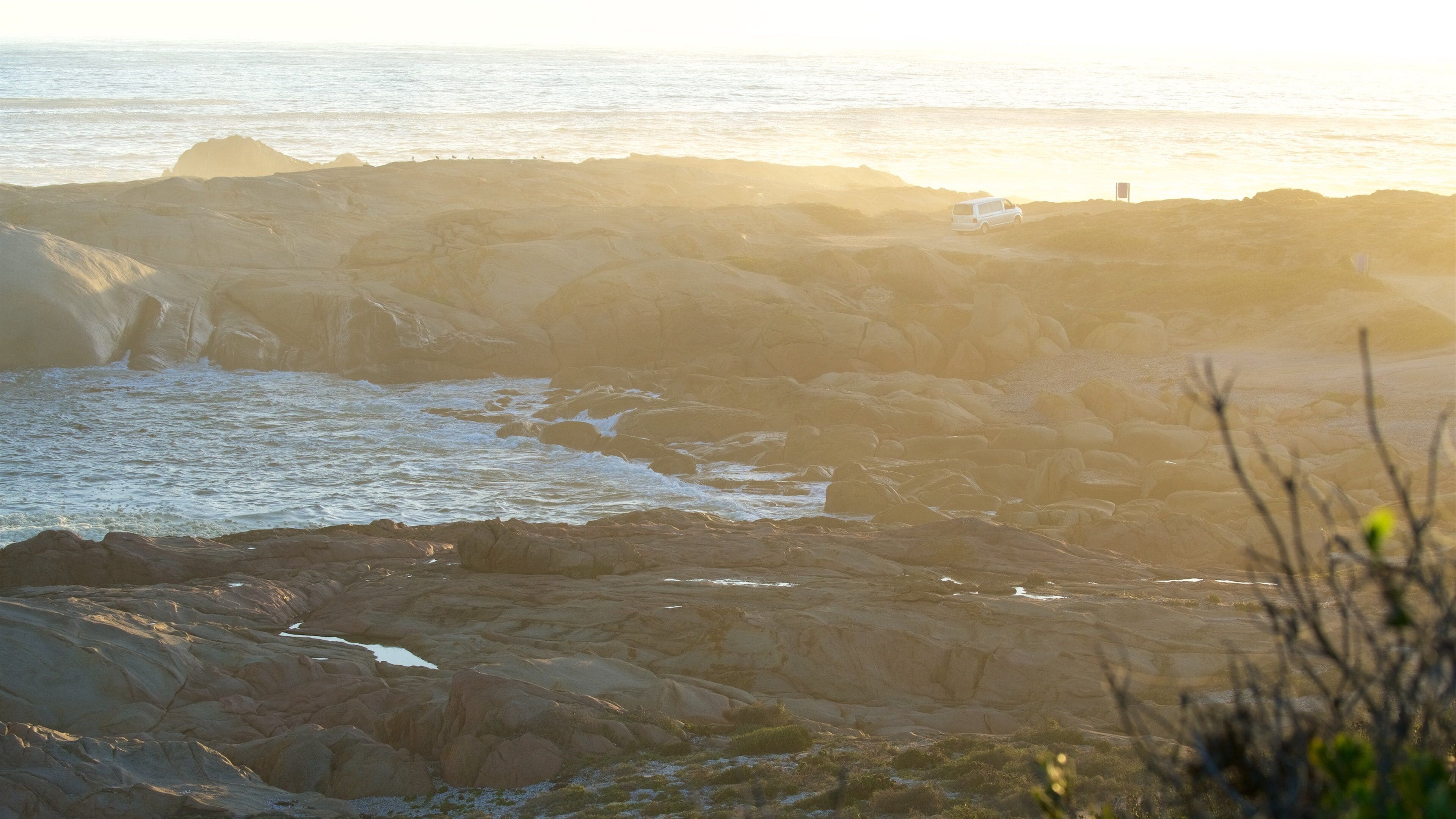Cape Columbine Lighthouse showing a sunset and rocky coastline