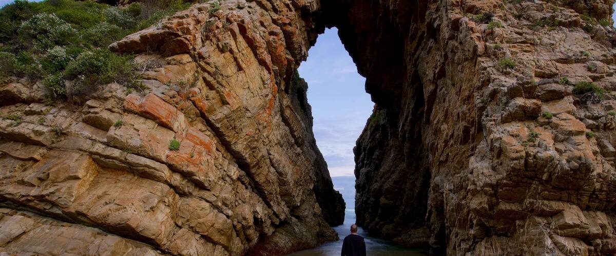 Arch Rock featuring rocky coastline as well as an individual male
