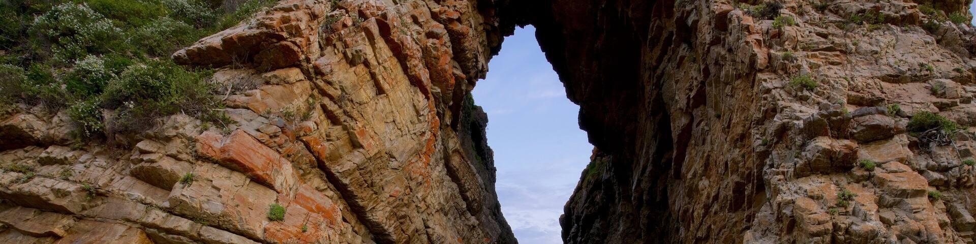 Arch Rock featuring rocky coastline as well as an individual male
