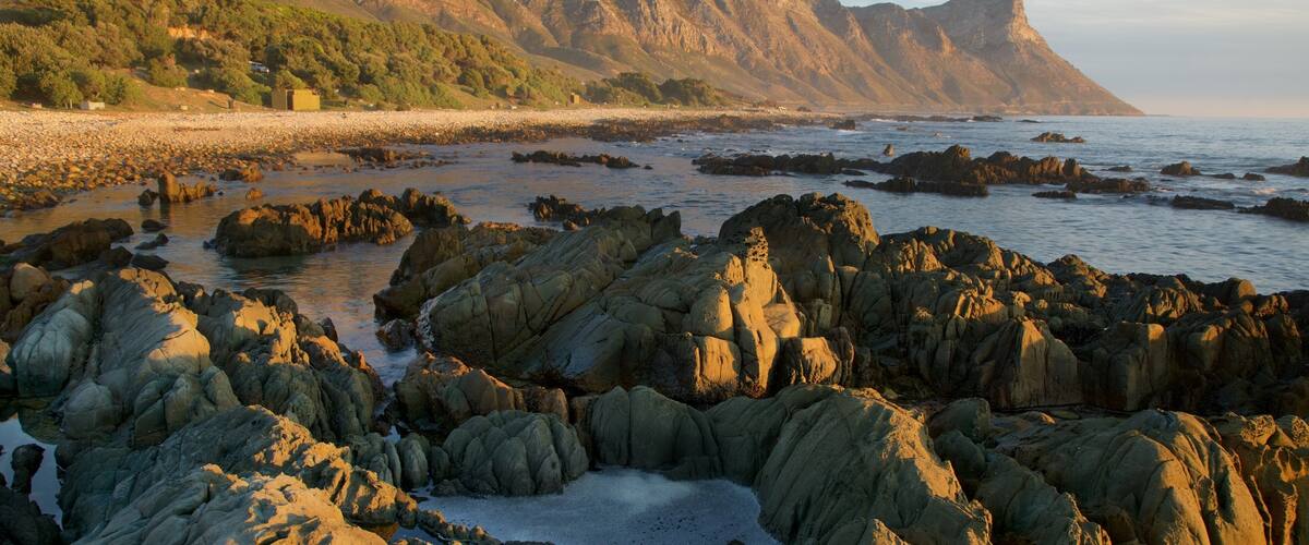 Kogel Bay Beach which includes a sunset and a pebble beach