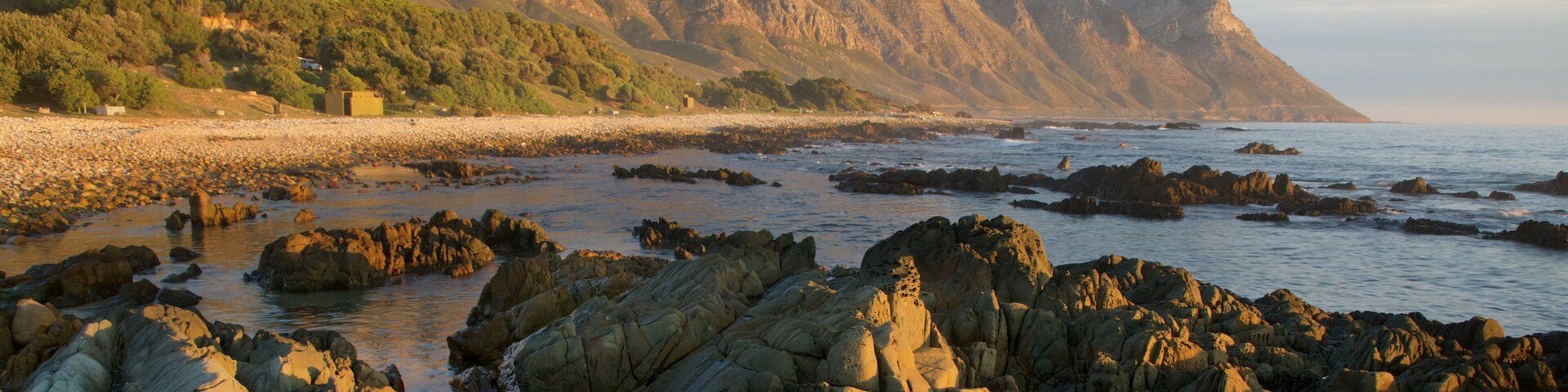 Kogel Bay Beach which includes a sunset and a pebble beach