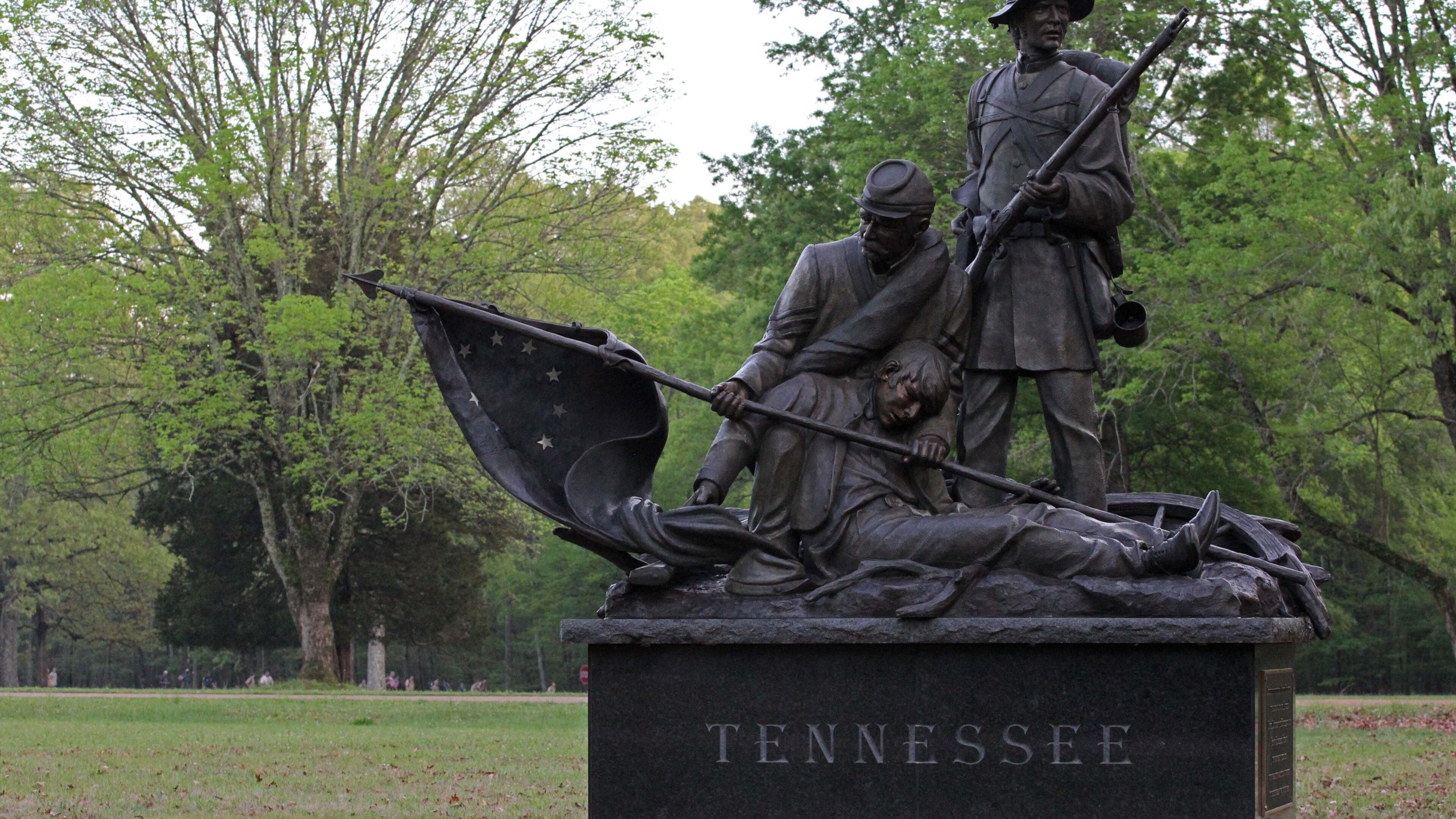 A statue of a soldier lying on the ground with a flag, another soldier standing beside him, and a third soldier holding a rifle. The base of the statue reads "Tennessee".