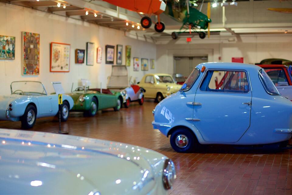 A vintage car museum with various classic cars on display.