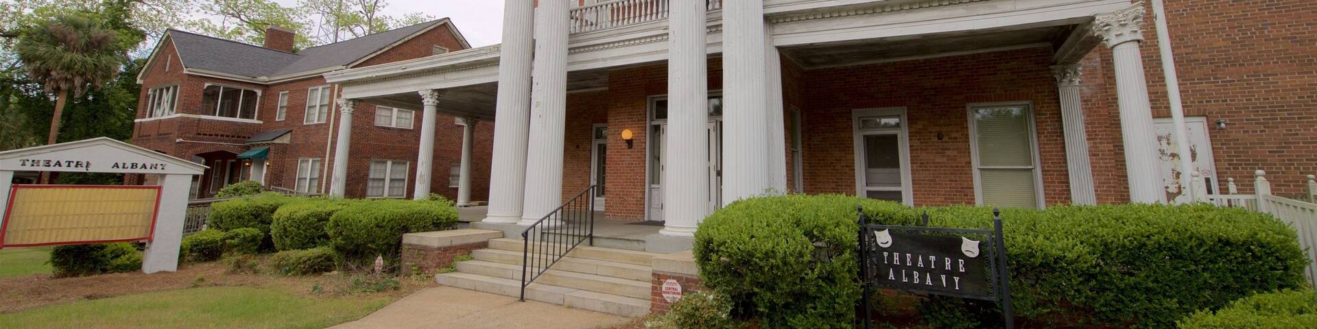 A historic brick building with white columns and a balcony, labeled "Theatre Albany."