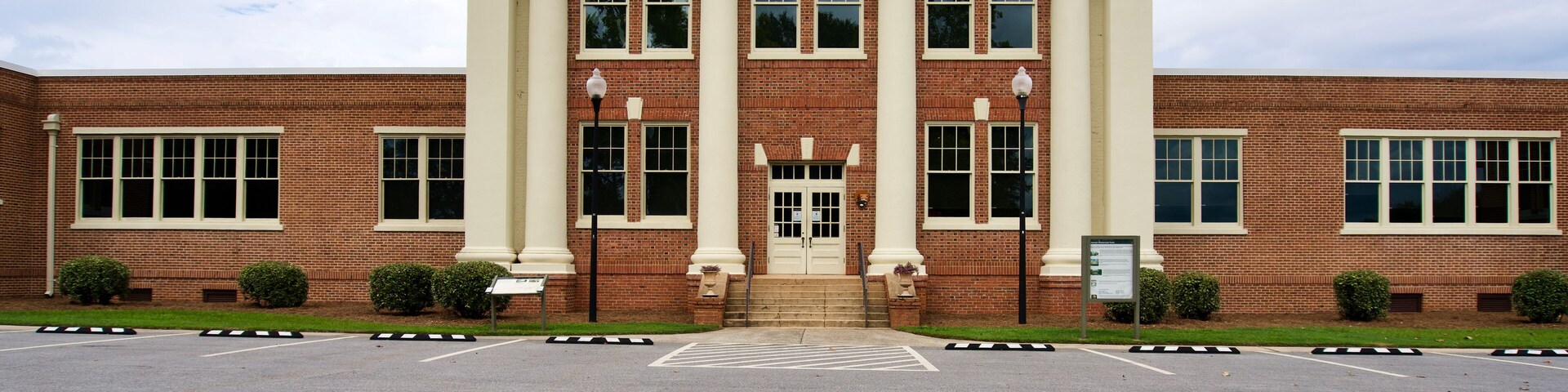 Plains, Georgia: Jimmy Carter National Historic Site. Former Plains High School serves as the park's museum and visitor center. Exterior entrance and parking area.