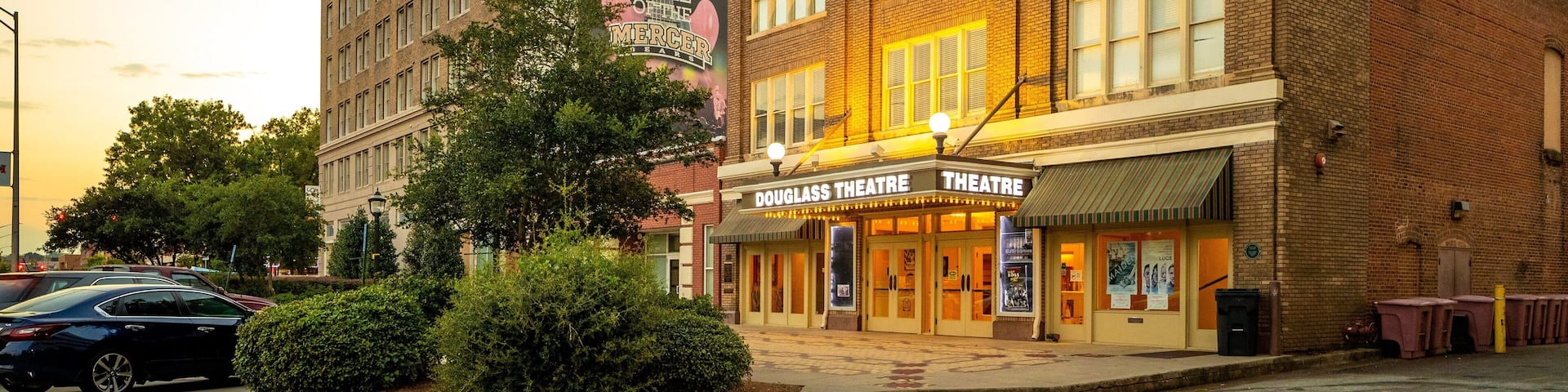 A historic building with a large billboard advertising a music event.