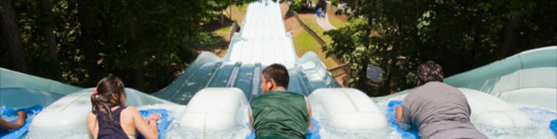 Six Flags White Water featuring a waterpark and rides as well as a small group of people