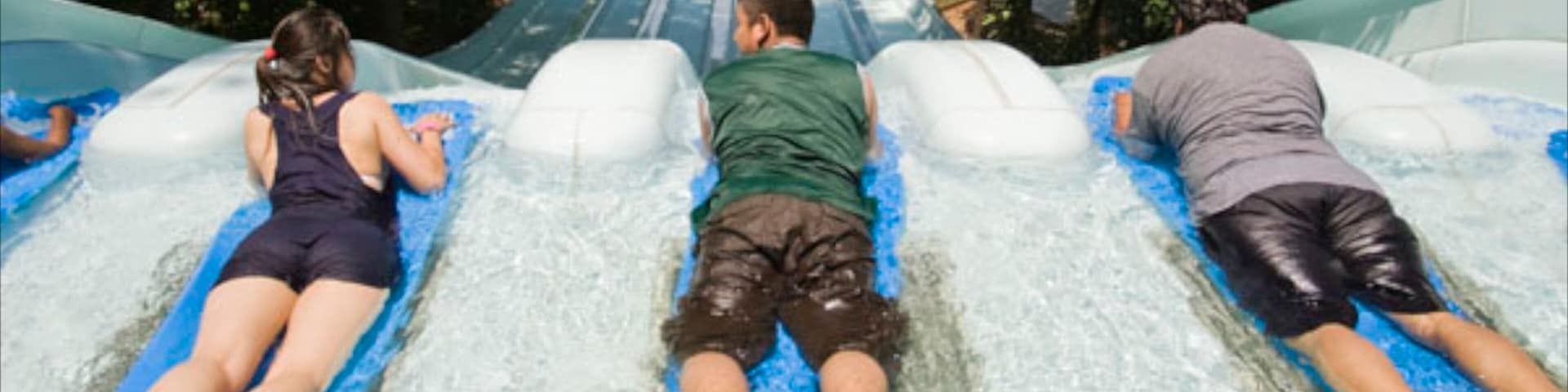 Six Flags White Water featuring a waterpark and rides as well as a small group of people