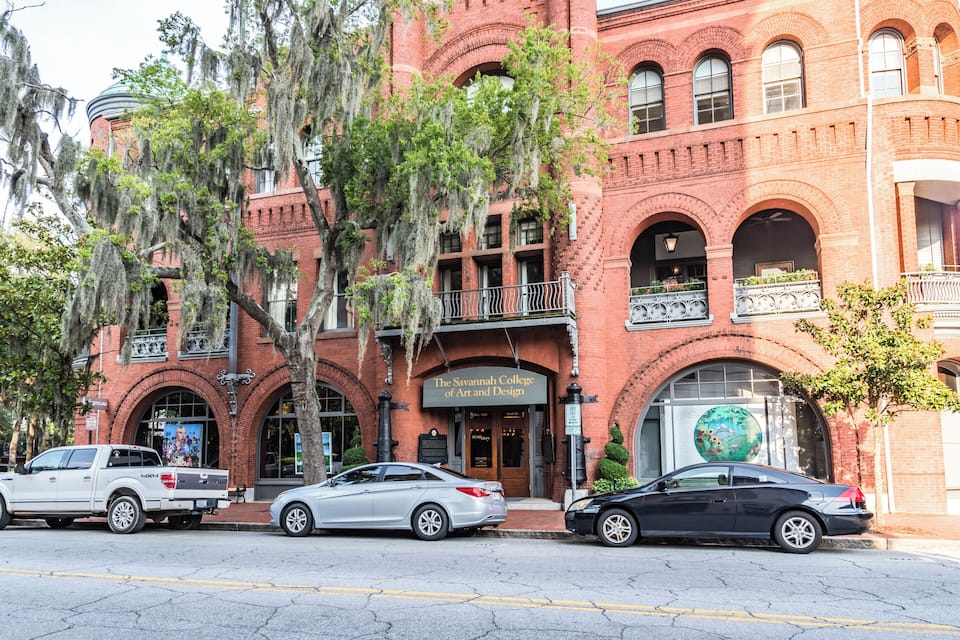A red brick building with a sign for The Savannah College of Art and Design.