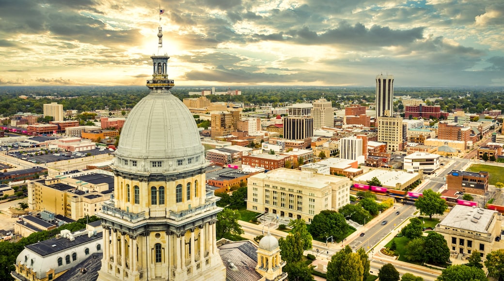 Aerial view of the Illinois State Capitol dome and Springfield skyline under a dramatic sunset. Springfield is the capital of the U.S. state of Illinois and the county seat of Sangamon County
