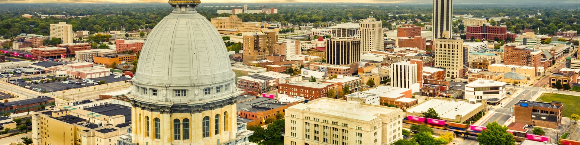 Aerial view of the Illinois State Capitol dome and Springfield skyline under a dramatic sunset. Springfield is the capital of the U.S. state of Illinois and the county seat of Sangamon County