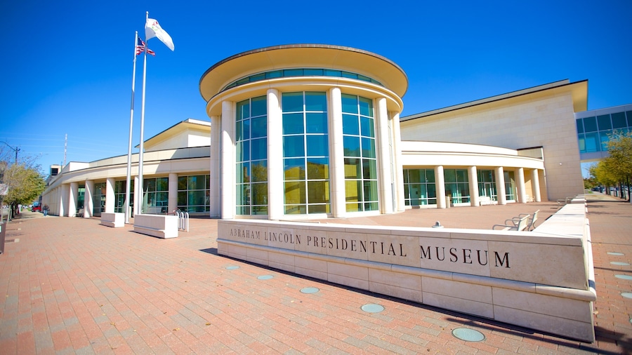The Abraham Lincoln Presidential Museum with a curved entrance, large windows, and a flagpole.