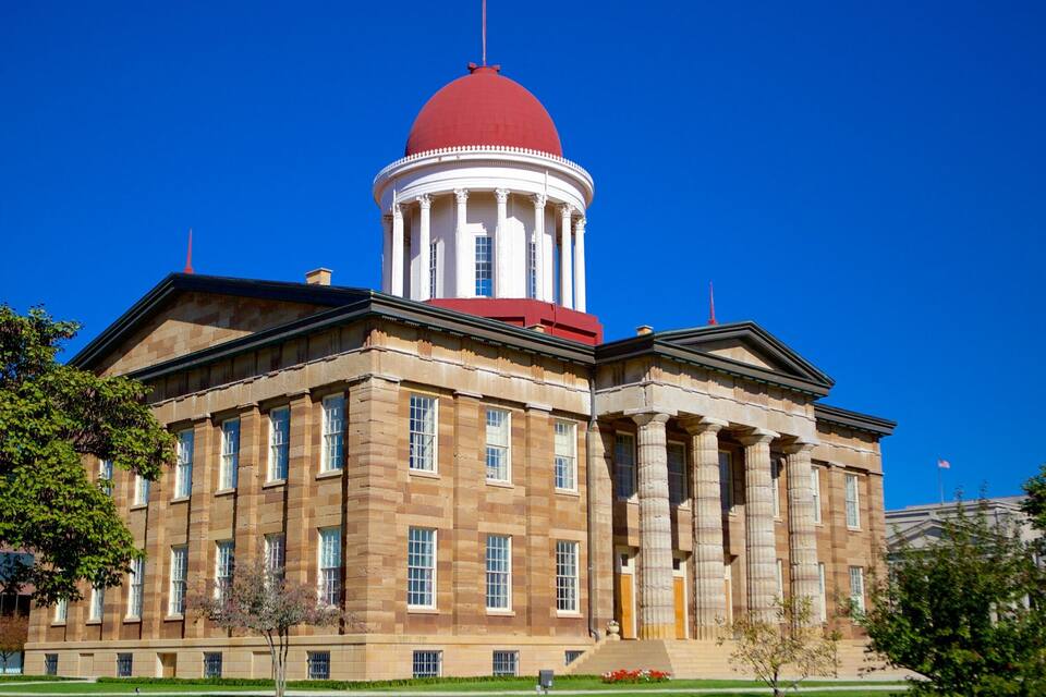 A large neoclassical building with a red dome and columns.