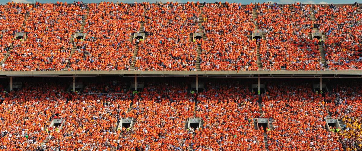 Crowd of thousands dressed in orange