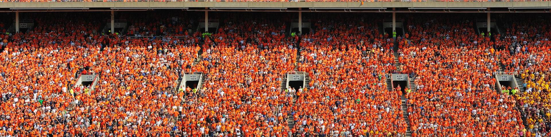 Crowd of thousands dressed in orange