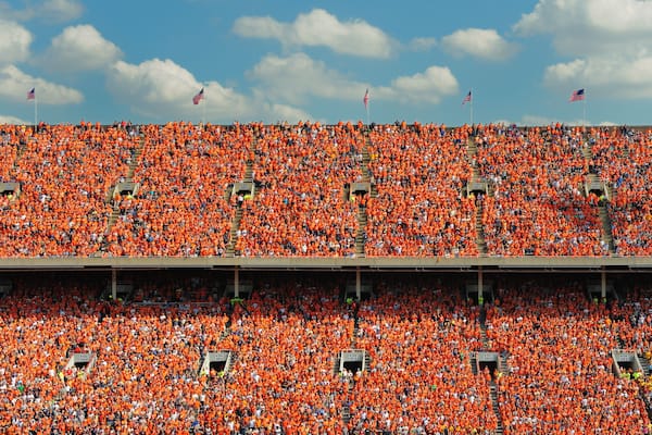 Crowd of thousands dressed in orange