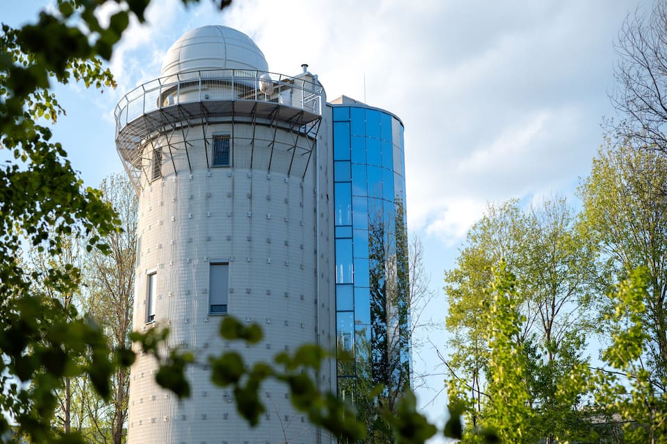 A cylindrical building with a dome and a blue glass facade.