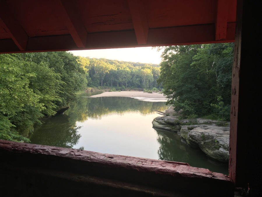 A view of a view from a coveraged bridge. This is just one of the many in the area, build in 1880's and still in good condition (just one of the reasons to cover the bridges is that they will last longer, don't believe aesthetics played a role in the design).
One way to explore Turkey Run State Park is by tube, kayak or canoe on the Sugar Creek. Snakes (friendly ones only), limestone rock formations and an old car (an Edsel?) stuck in the banks of the river can be admired from the water. This park is a true Hoosier trove.
http://www.in.gov/dnr/parklake/2964.htm
If you are into covered bridges: http://www.coveredbridges.com/