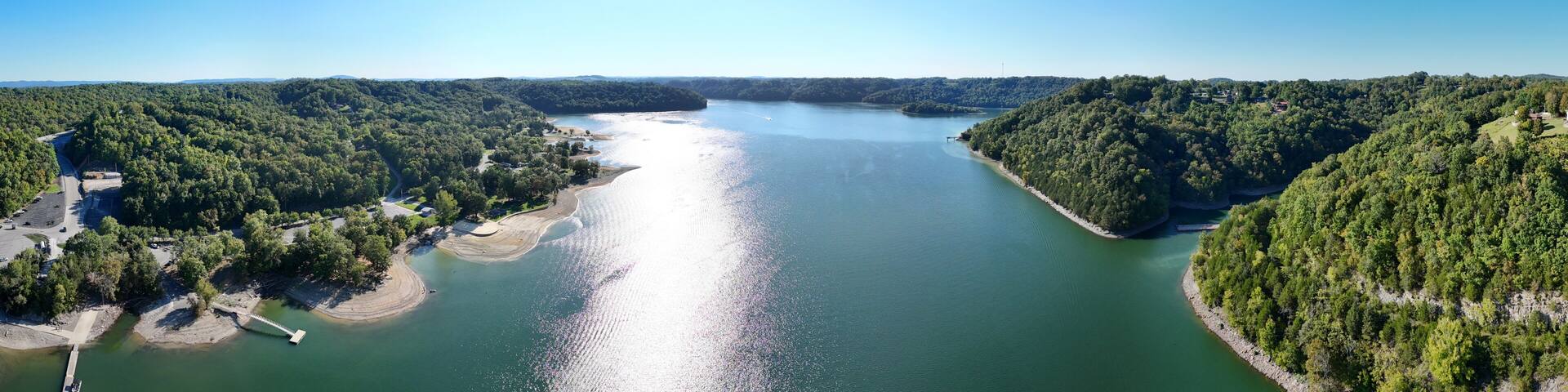 Aerial View of the Lakeside Sunset Marina Resort on Dale Hollow Lake With Highway 111 Bridge, Boats and Forested Shoreline, Calm Water on a Sunny Day, Monroe, Tennessee, USA.
