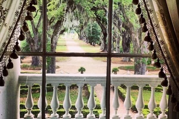 Looking out of the Master bedroom of the Rosedown Plantation. Sugarcane Plantation. Spring