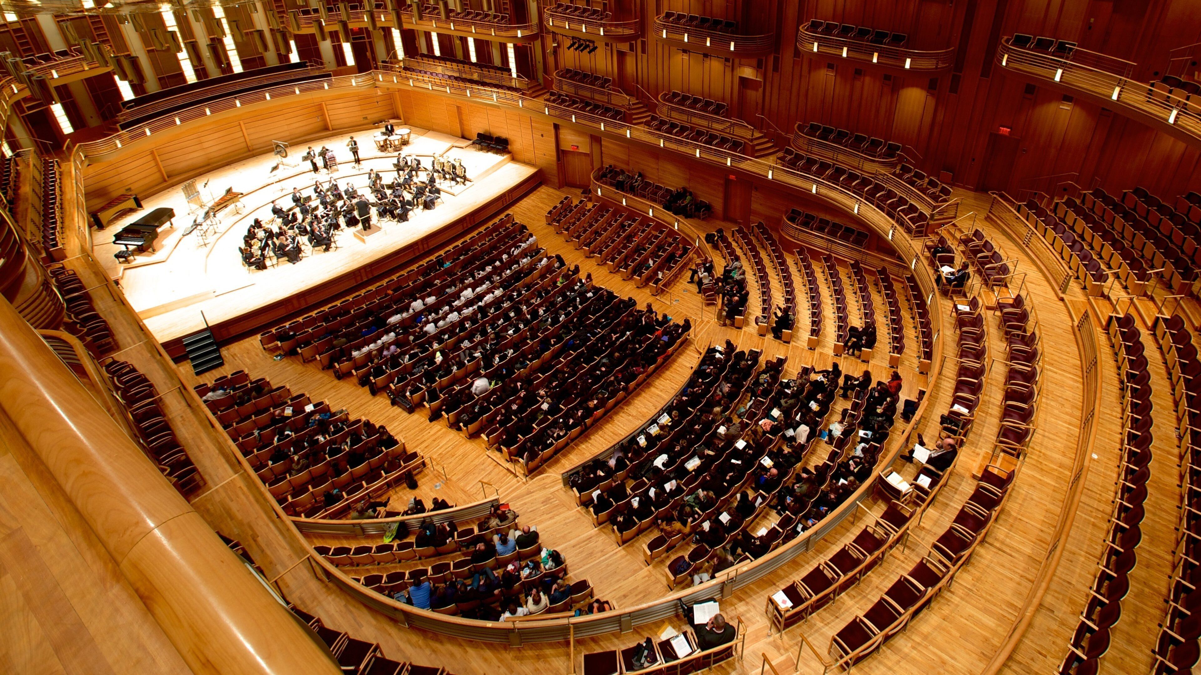 A large, circular auditorium with tiered seating and a stage at the front.