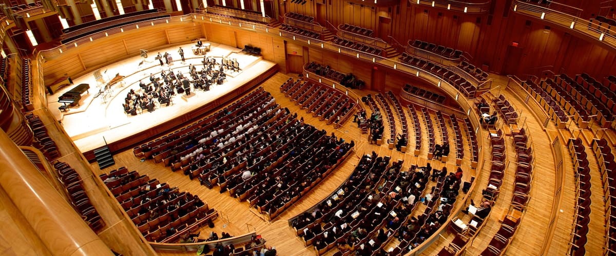 A large, circular auditorium with tiered seating and a stage at the front.