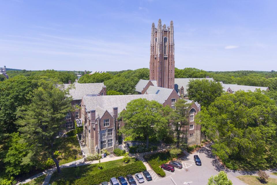 A large church with a tall tower surrounded by trees.