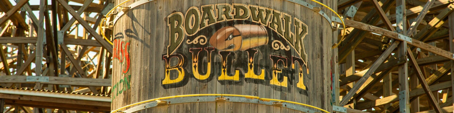 A wooden barrel with the words "Boardwalk Bull" painted on it, surrounded by a metal framework.