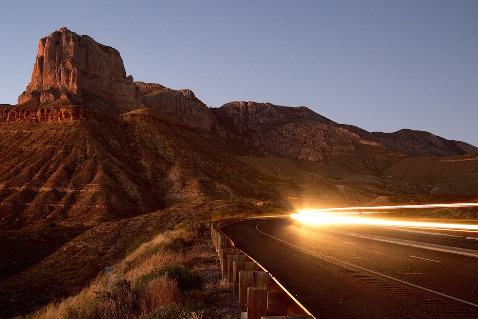 A highway with a mountain in the background.
