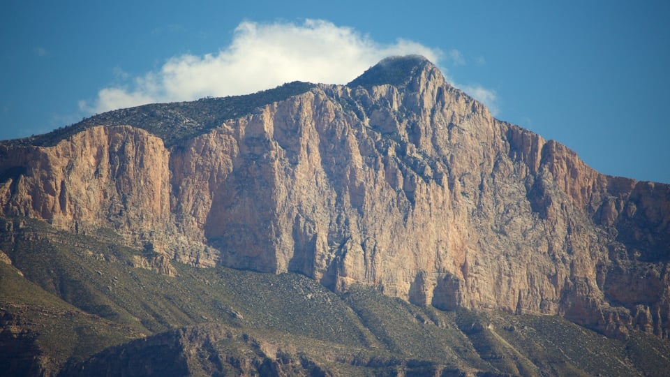 A rugged mountain with steep cliffs and sparse vegetation.