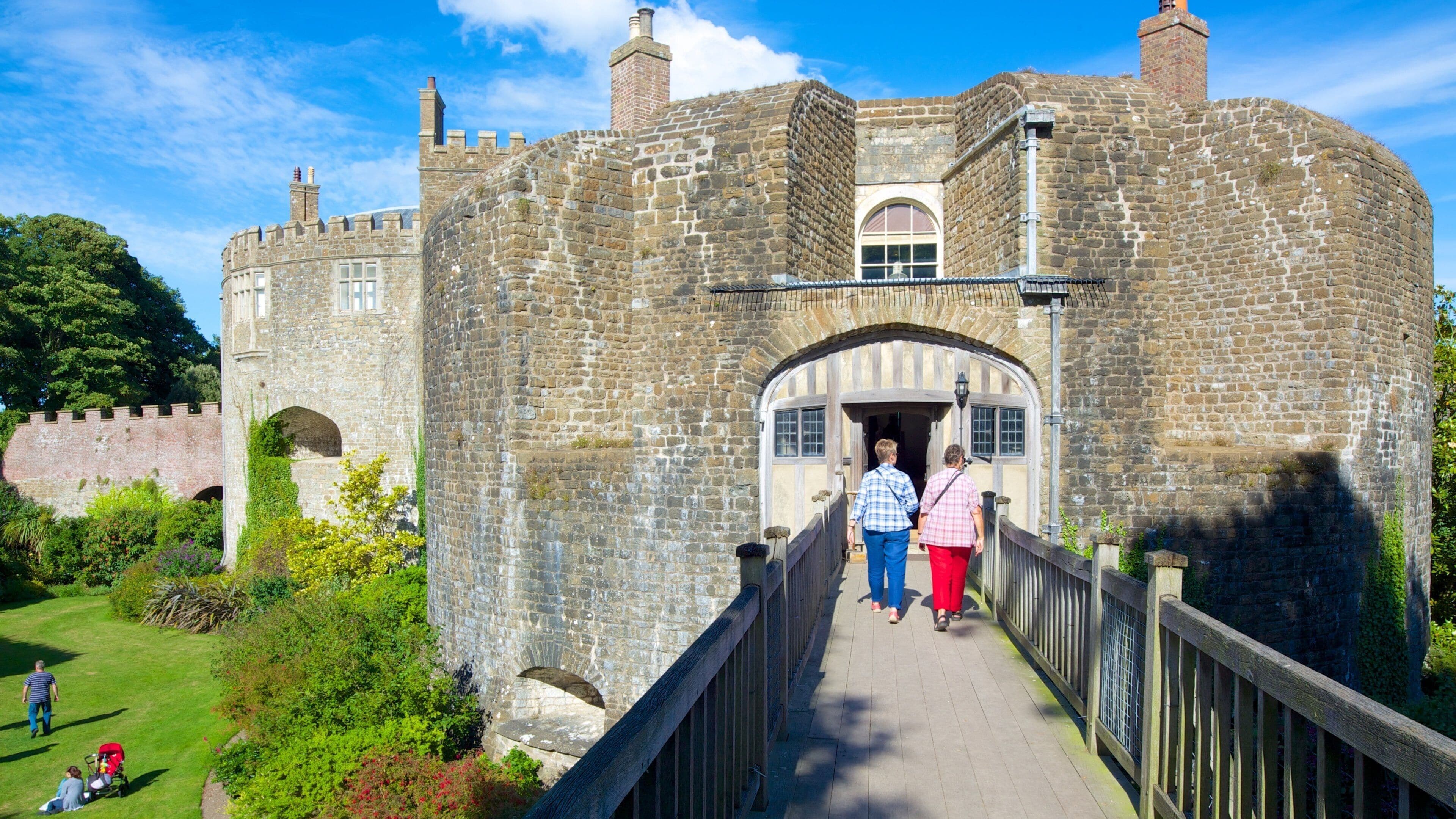 Walmer Castle and Gardens which includes chateau or palace and a bridge as well as a small group of people
