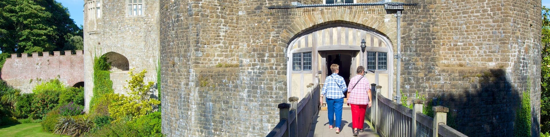 Walmer Castle and Gardens which includes chateau or palace and a bridge as well as a small group of people