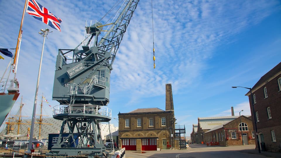 A crane, a British flag, and a historic building with red doors.