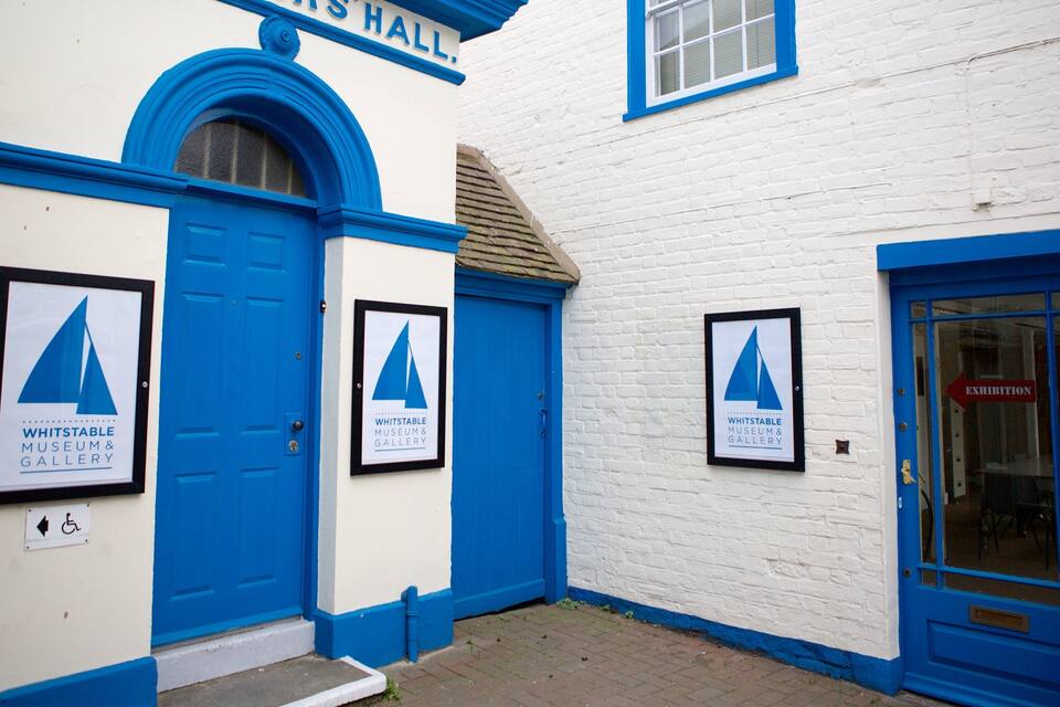 A building with blue doors and windows, labeled "WHITSTABLE MUSEUM & GALLERY".