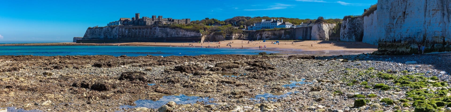 MARGATE, Kent, UK: 21 May 2020: Visitors to Margate's Main Sands beach surrounded by white cliffs during the heatwave in Britain.
