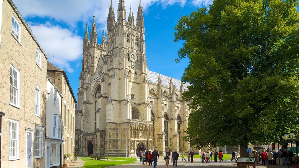 A historic cathedral with intricate architecture and a crowd of people in the foreground.