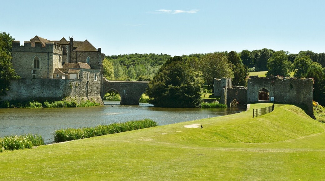 Leeds Castle is in Kent, England, 5 miles (8 km) southeast of Maidstone. A castle has been on the site since 1119. In the 13th century it came into the hands of King Edward I, for whom it became a favourite residence; in the 16th century, Henry VIII used it as a dwelling for his first wife, Catherine of Aragon. The castle today dates mostly from the 19th century and is built on islands in a lake formed by the River Len to the east of the village of Leeds. It has been open to the public since 1976