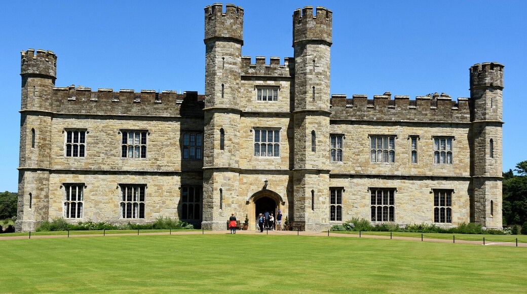 Leeds Castle is in Kent, England, 5 miles (8 km) southeast of Maidstone. A castle has been on the site since 1119. In the 13th century it came into the hands of King Edward I, for whom it became a favourite residence; in the 16th century, Henry VIII used it as a dwelling for his first wife, Catherine of Aragon. The castle today dates mostly from the 19th century and is built on islands in a lake formed by the River Len to the east of the village of Leeds. It has been open to the public since 1976