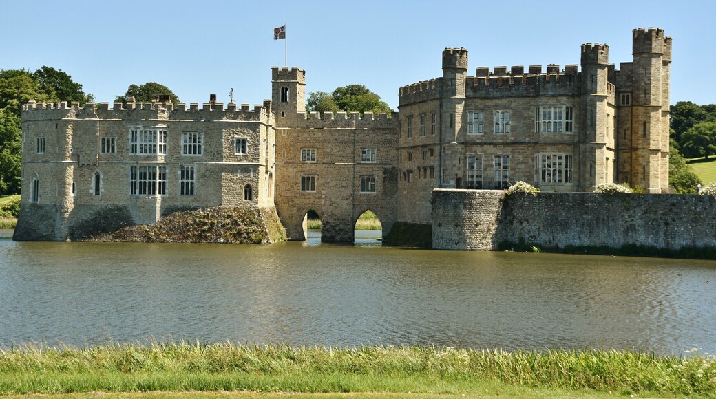 Leeds Castle is in Kent, England, 5 miles (8 km) southeast of Maidstone. A castle has been on the site since 1119. In the 13th century it came into the hands of King Edward I, for whom it became a favourite residence; in the 16th century, Henry VIII used it as a dwelling for his first wife, Catherine of Aragon. The castle today dates mostly from the 19th century and is built on islands in a lake formed by the River Len to the east of the village of Leeds. It has been open to the public since 1976