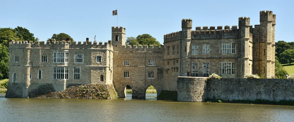 Leeds Castle is in Kent, England, 5 miles (8 km) southeast of Maidstone. A castle has been on the site since 1119. In the 13th century it came into the hands of King Edward I, for whom it became a favourite residence; in the 16th century, Henry VIII used it as a dwelling for his first wife, Catherine of Aragon. The castle today dates mostly from the 19th century and is built on islands in a lake formed by the River Len to the east of the village of Leeds. It has been open to the public since 1976