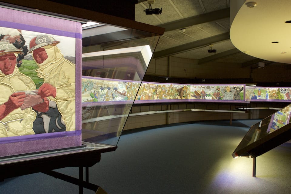 An exhibition with framed artworks on display.