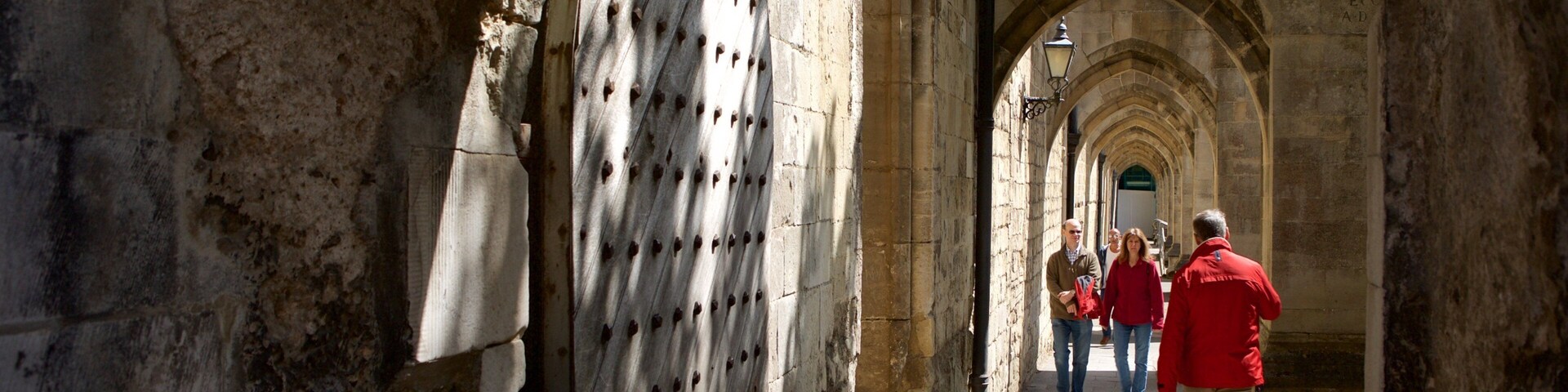 Winchester Cathedral featuring heritage architecture as well as a small group of people