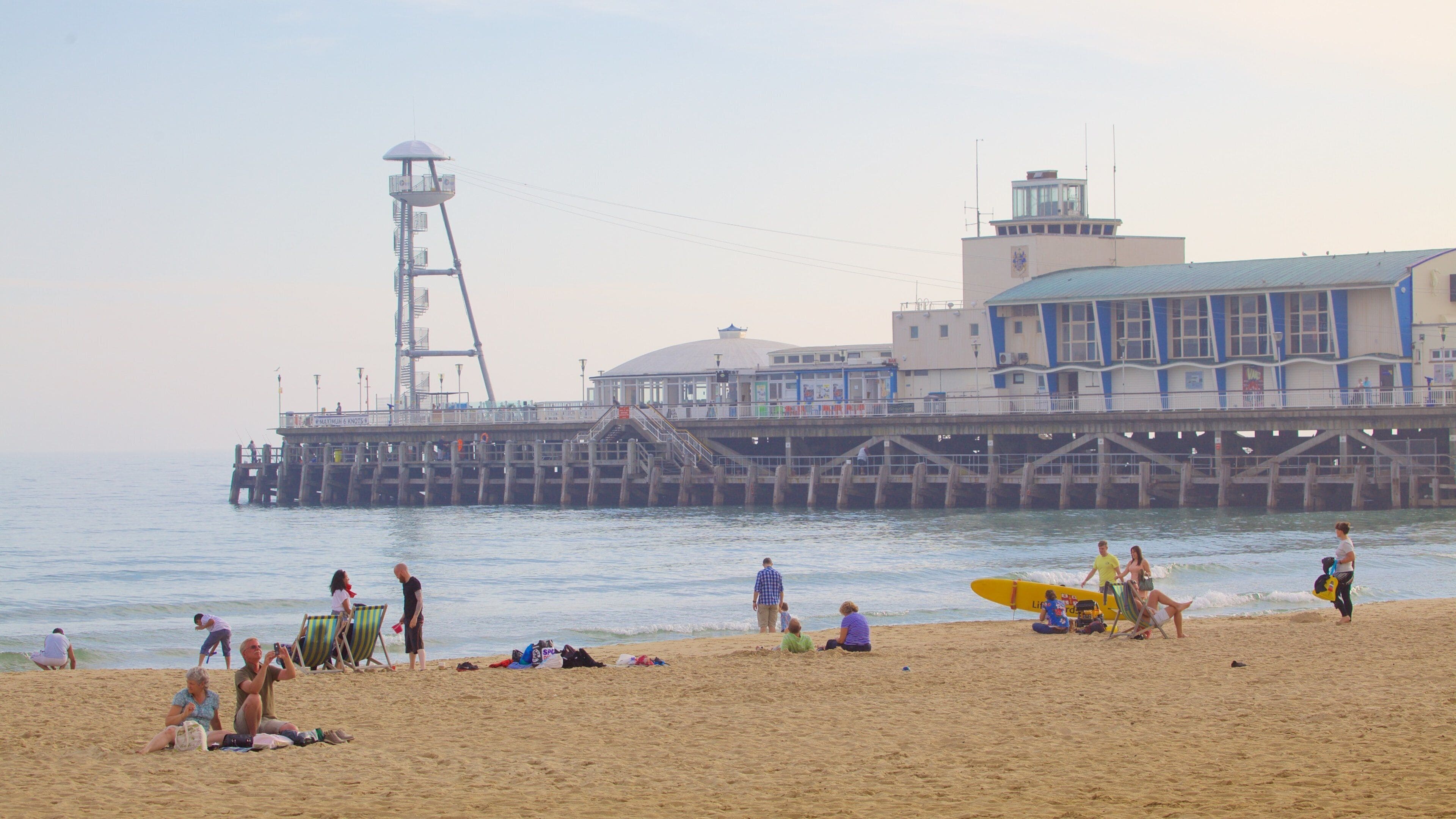 Bournemouth Beach featuring a sandy beach as well as a small group of people