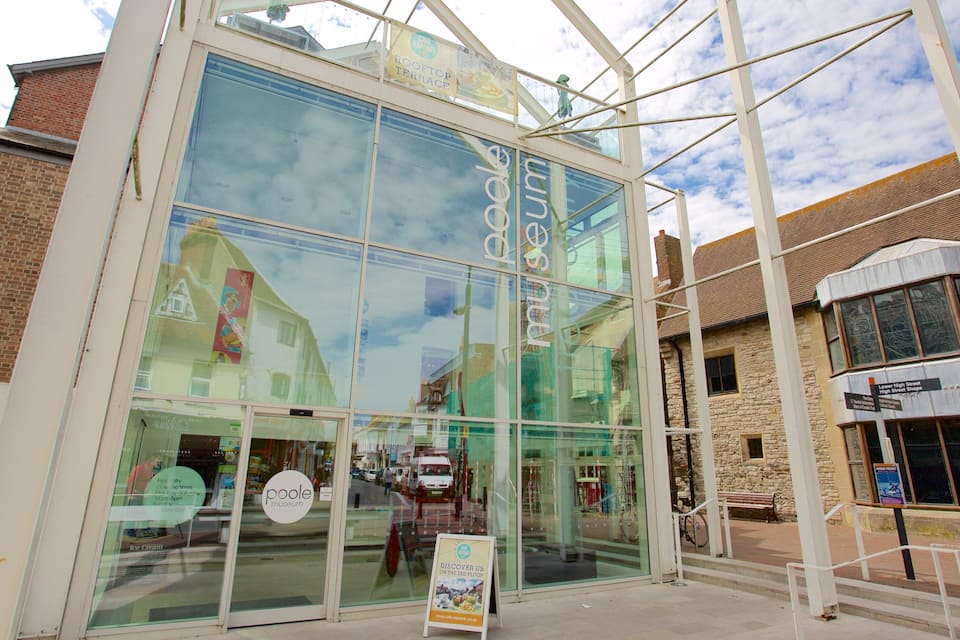 The Poole Museum building with a glass facade and signage for the Rooftop Terrace.