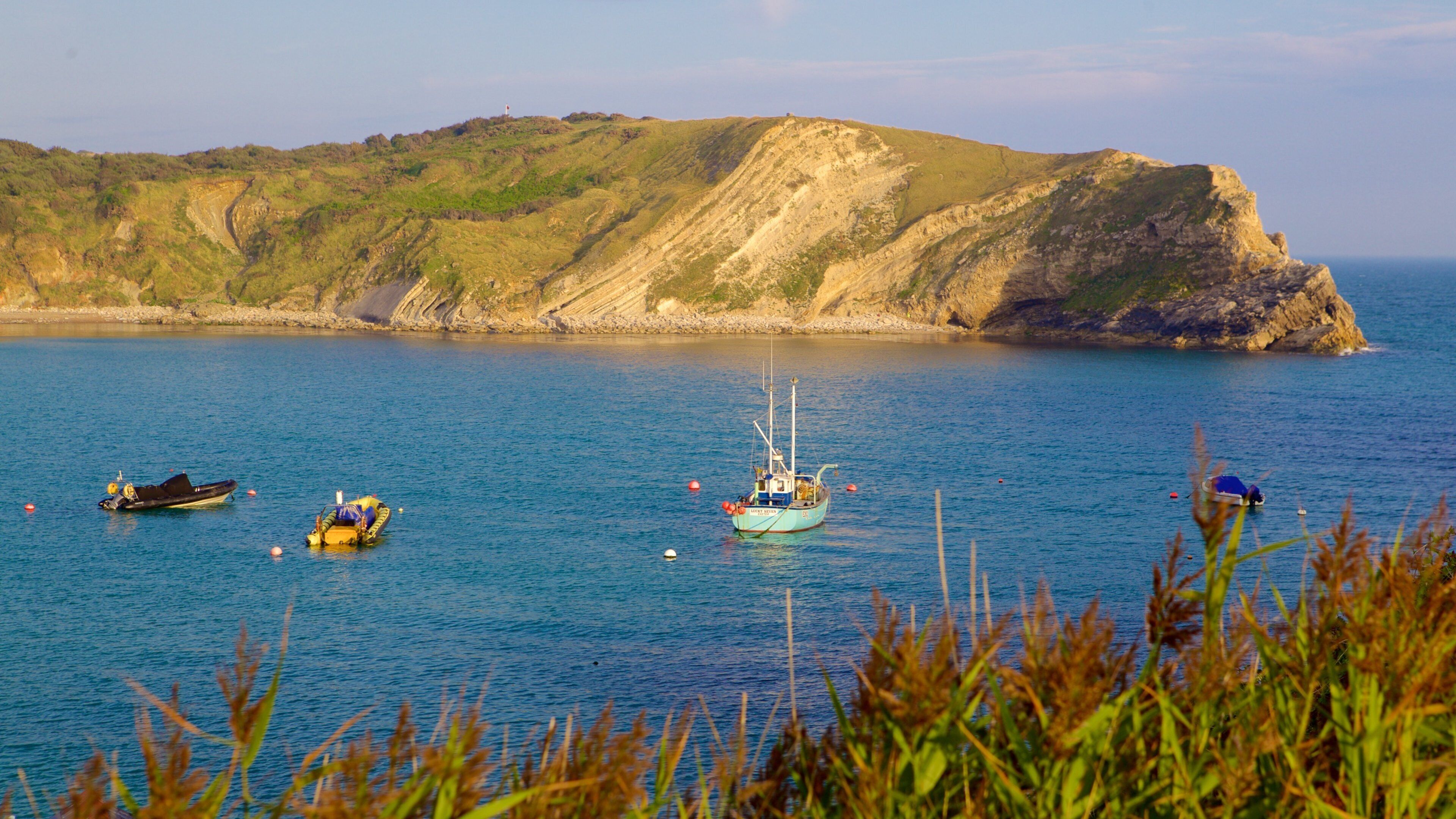 Lulworth Cove Beach which includes boating and a bay or harbor