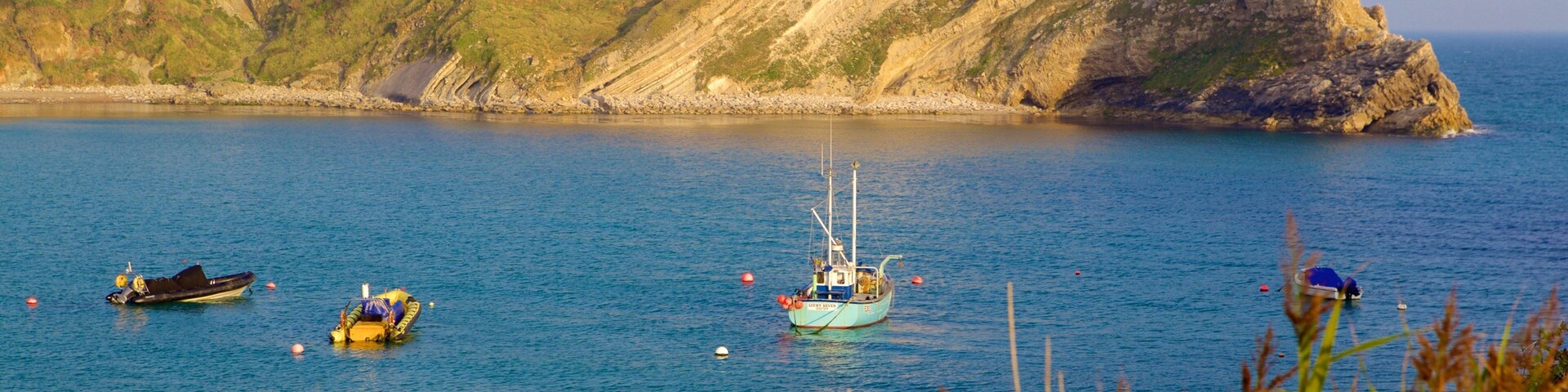 Lulworth Cove Beach which includes boating and a bay or harbor