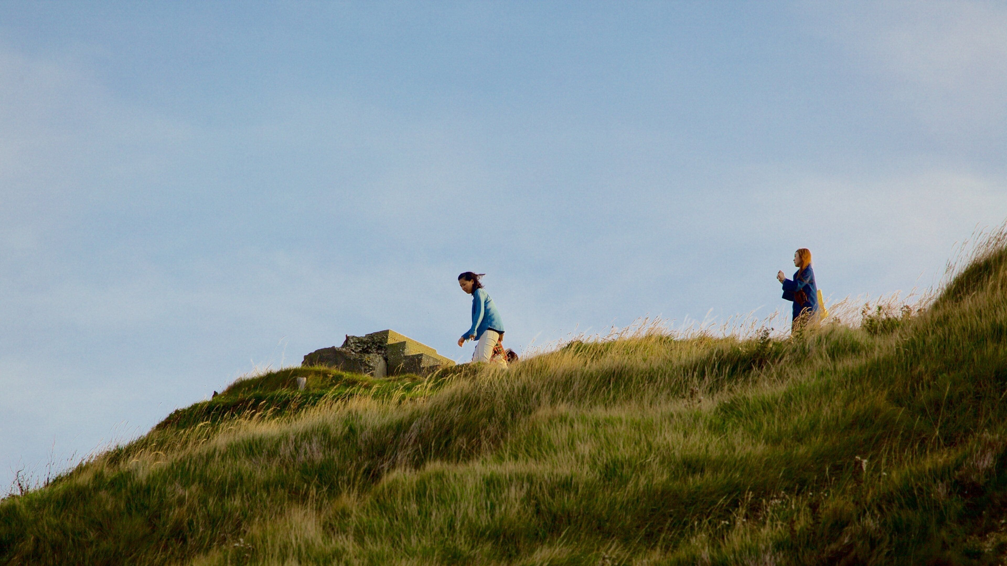Lulworth Cove Beach featuring tranquil scenes as well as a small group of people