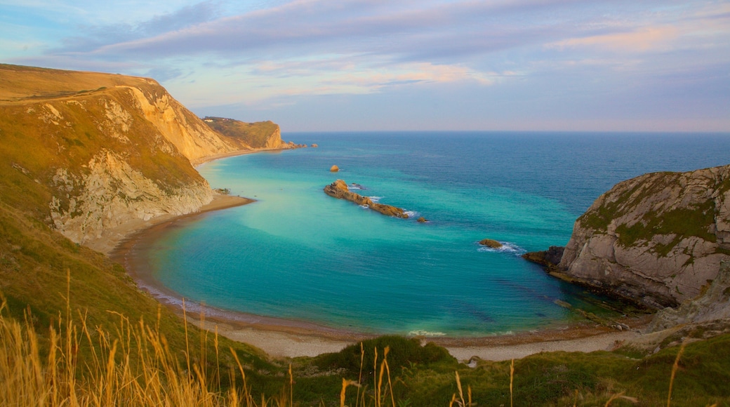 Durdle Door which includes a bay or harbor and rocky coastline