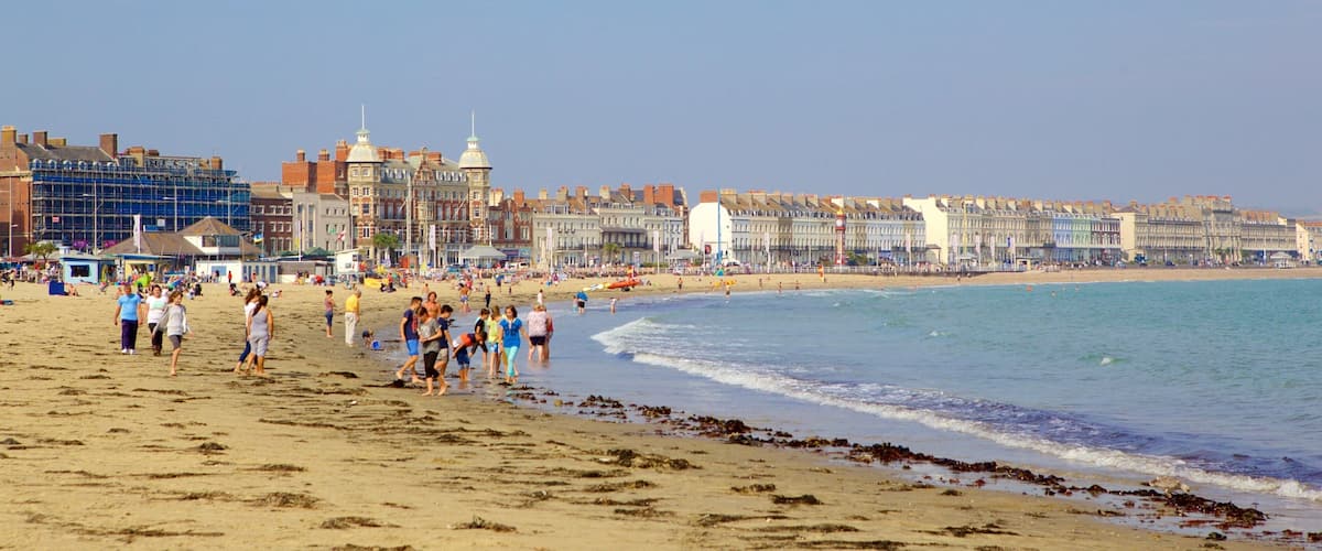 Weymouth Beach showing a sandy beach as well as a small group of people