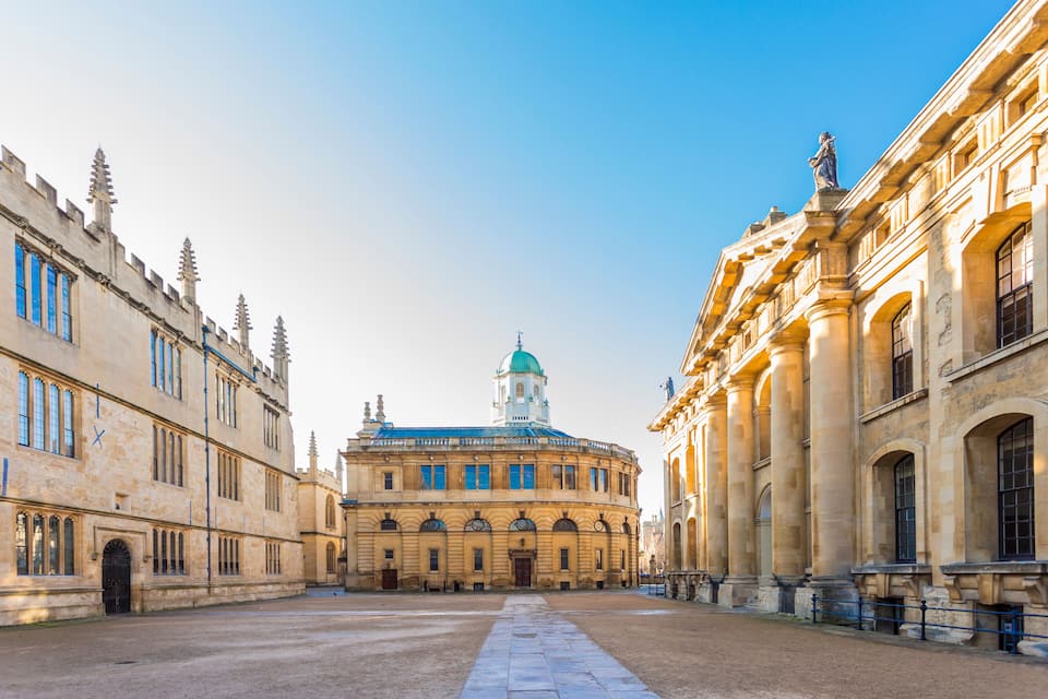 A historic building with a dome and spires, surrounded by a courtyard.